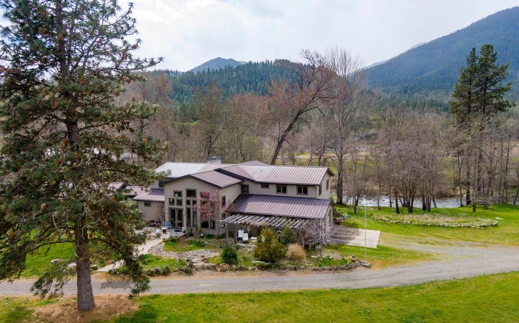2076 Upper Applegate Road Jacksonville, OR 97530 - Photo 2 of 35 a view of a big house with a big yard and large trees