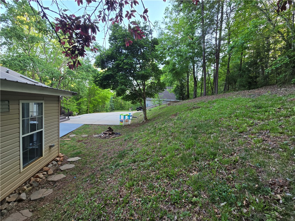130 Greenbrier Road Salem, SC 29676 - Photo 46 of 48 This property features a spacious yard and wooded surroundings, perfect for outdoor activities.