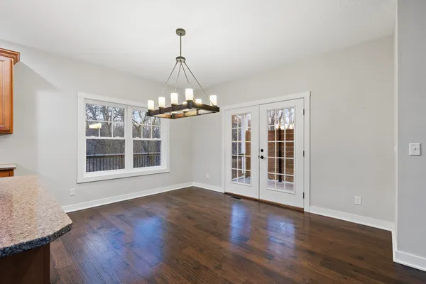 a view of kitchen with wooden floor and electronic appliances