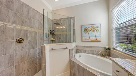 a en suite bathroom with a granite countertop sink and a mirror