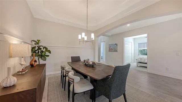 a view of a dining room with furniture and wooden floor