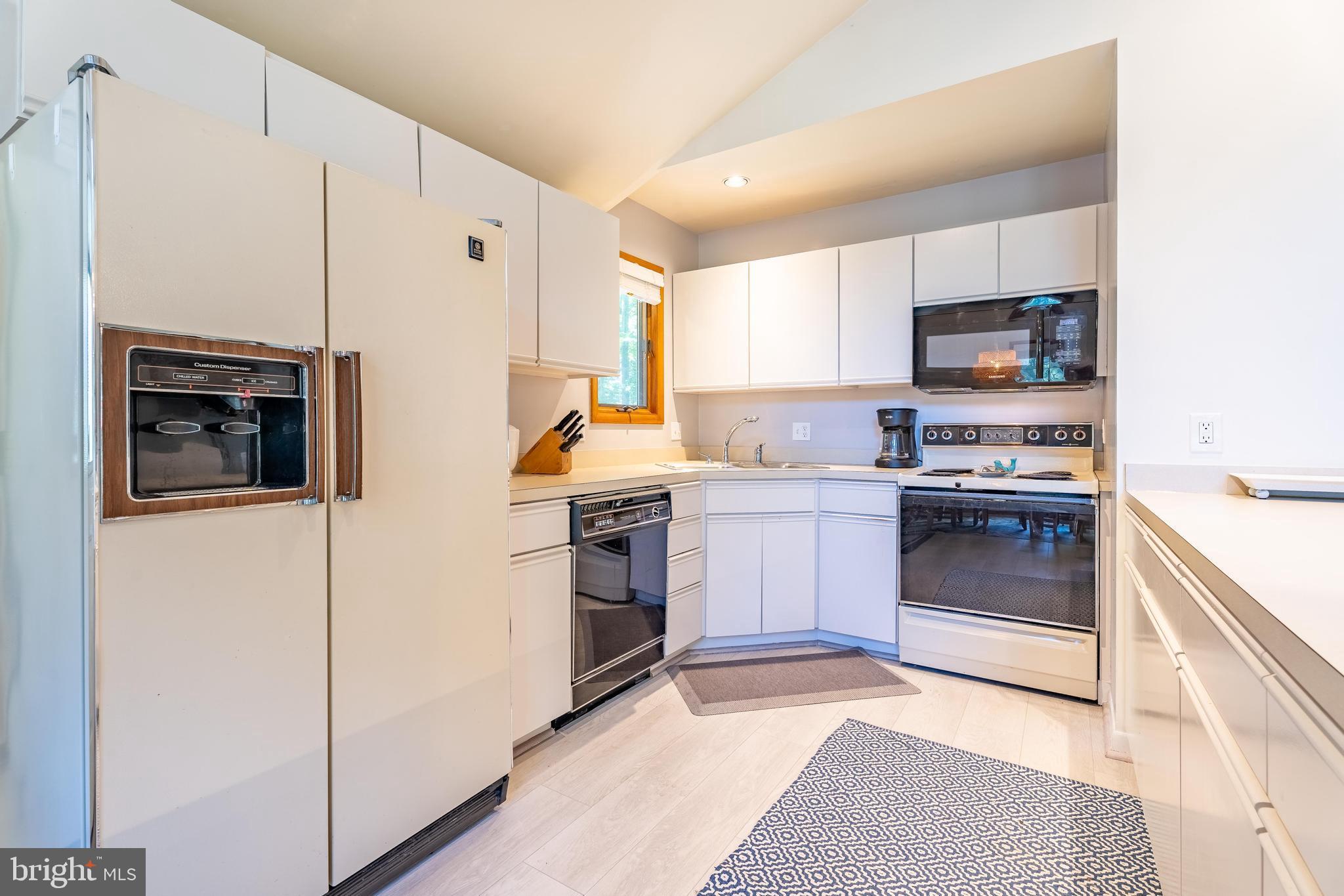122 Nottingham Lane Ocean Pines, MD 21811 - Photo 11 of 45 a kitchen with a refrigerator sink and cabinets