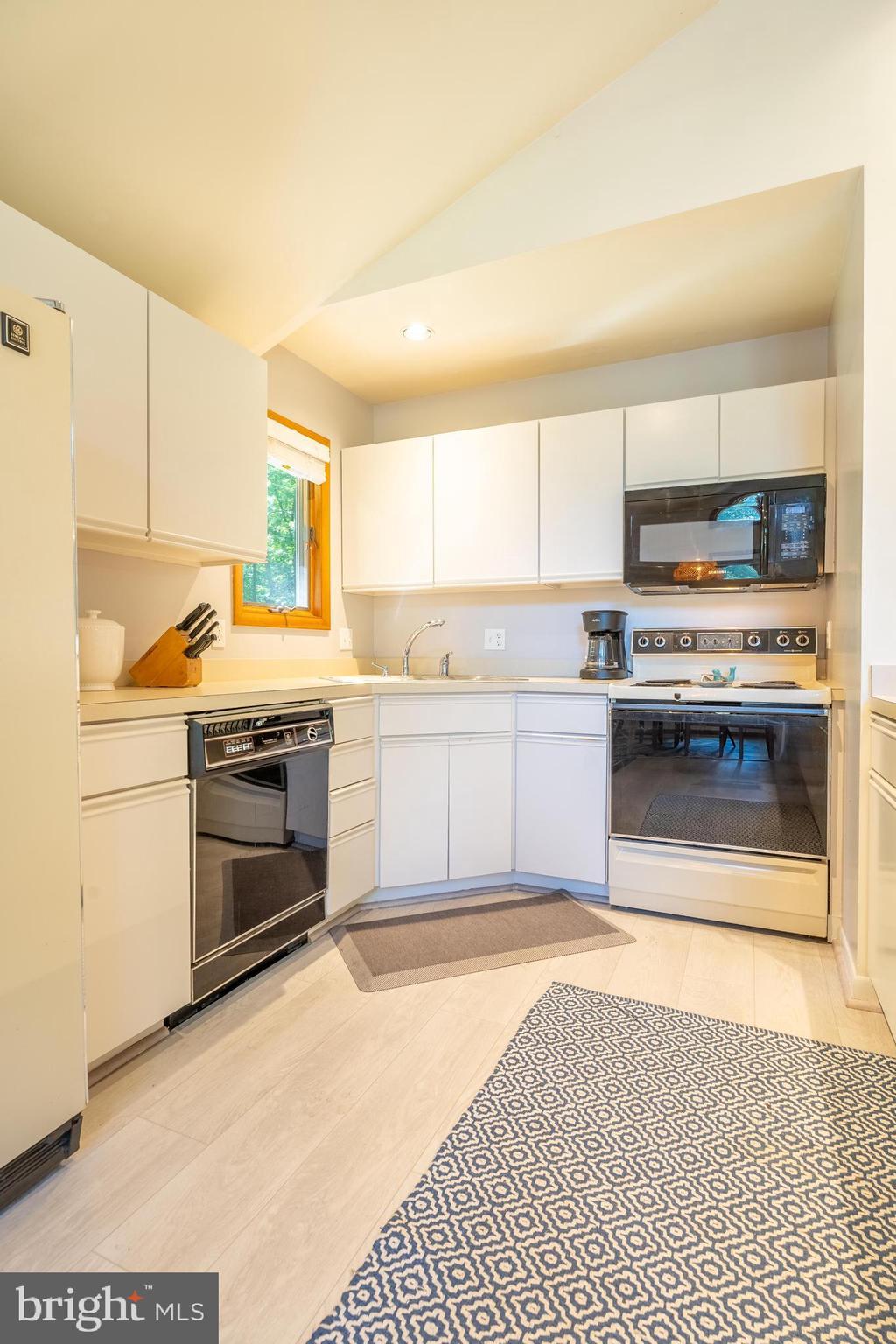 122 Nottingham Lane Ocean Pines, MD 21811 - Photo 12 of 45 a kitchen with a stove a sink and a refrigerator