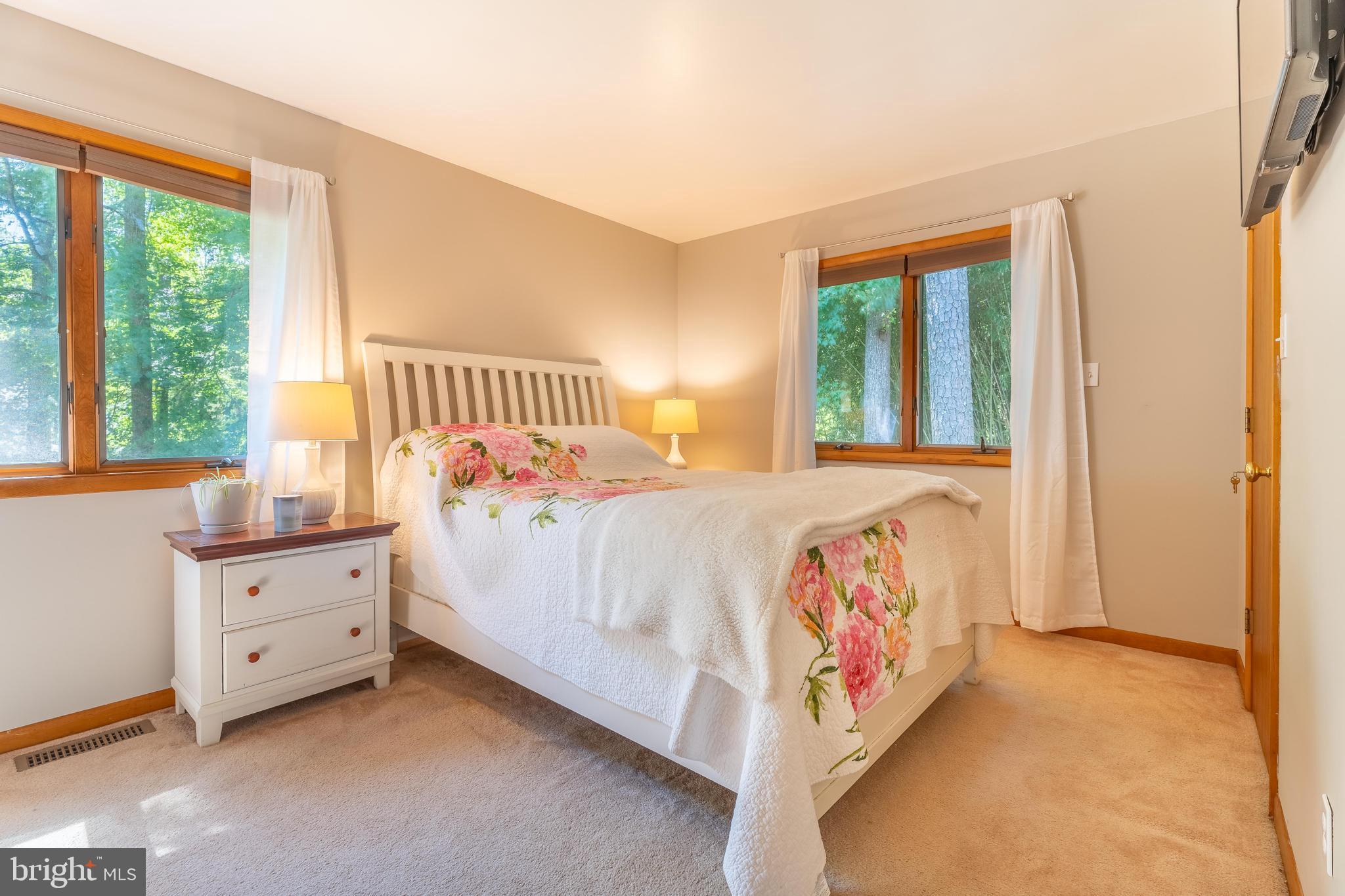 122 Nottingham Lane Ocean Pines, MD 21811 - Photo 14 of 45 a bedroom with a large bed and a window