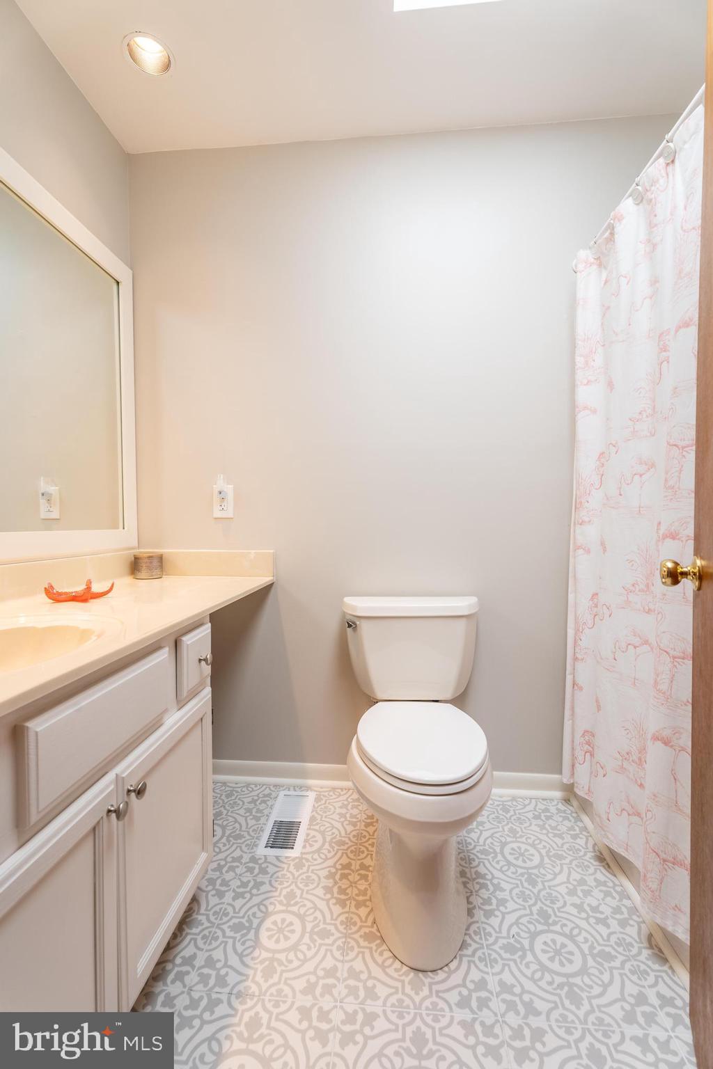 122 Nottingham Lane Ocean Pines, MD 21811 - Photo 27 of 45 a bathroom with a sink a toilet and a mirror