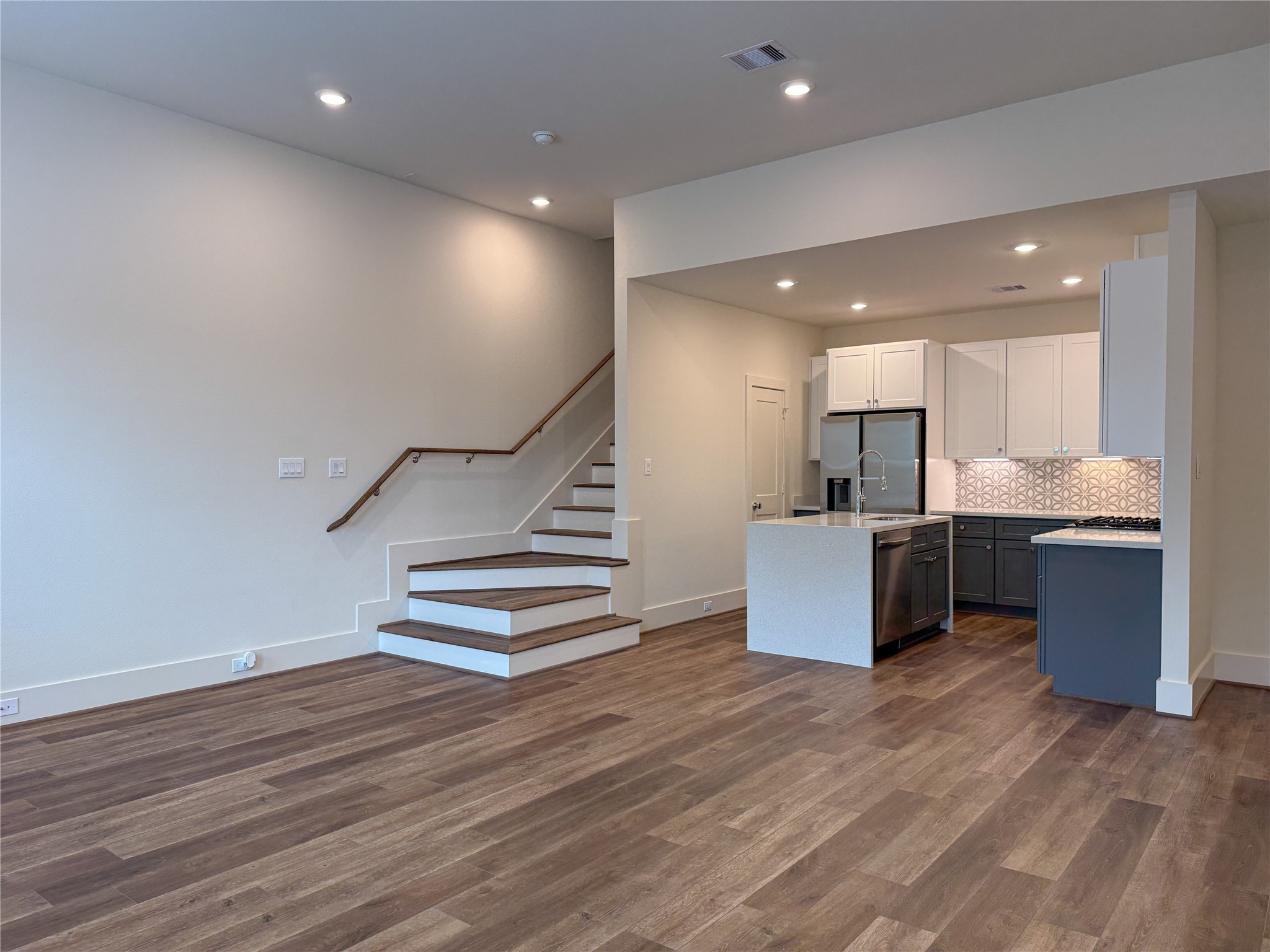 879 Rachel Street, Unit D Houston, TX 77091 - Photo 5 of 29 a room with wooden floors and kitchen view