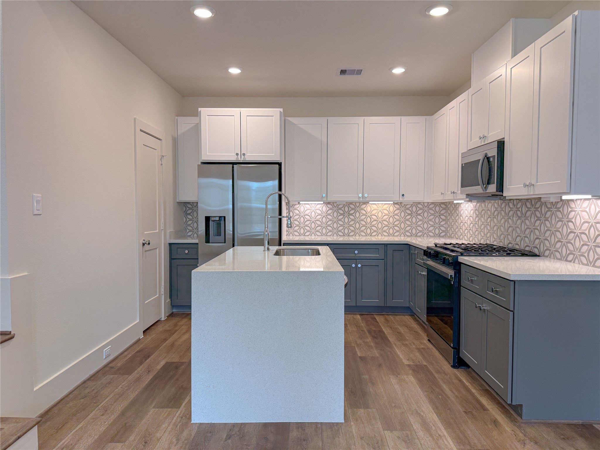 879 Rachel Street, Unit D Houston, TX 77091 - Photo 7 of 29 a kitchen with kitchen island granite countertop wooden cabinets and white stainless steel appliances