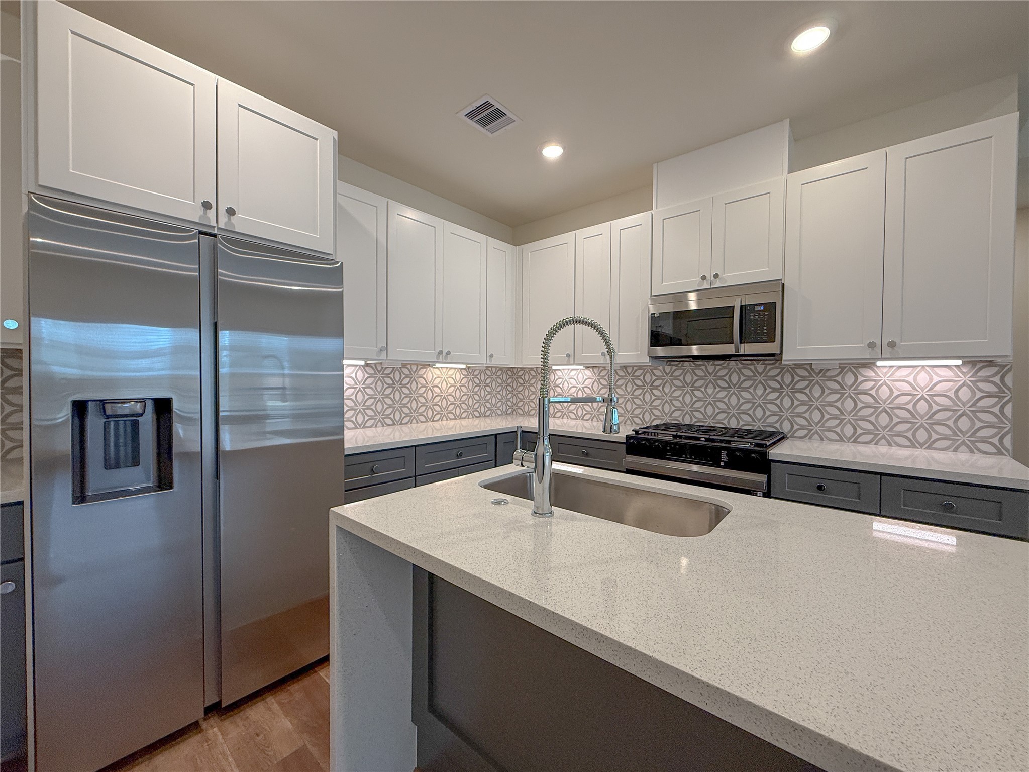 879 Rachel Street, Unit D Houston, TX 77091 - Photo 10 of 29 a kitchen with granite countertop a sink stainless steel appliances and cabinets