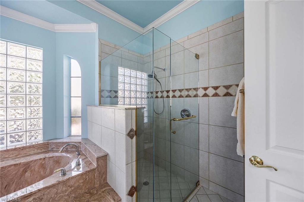146 Windward Cay Naples, FL 34114 - Photo 17 of 33 a bathroom with a bathtub and shower