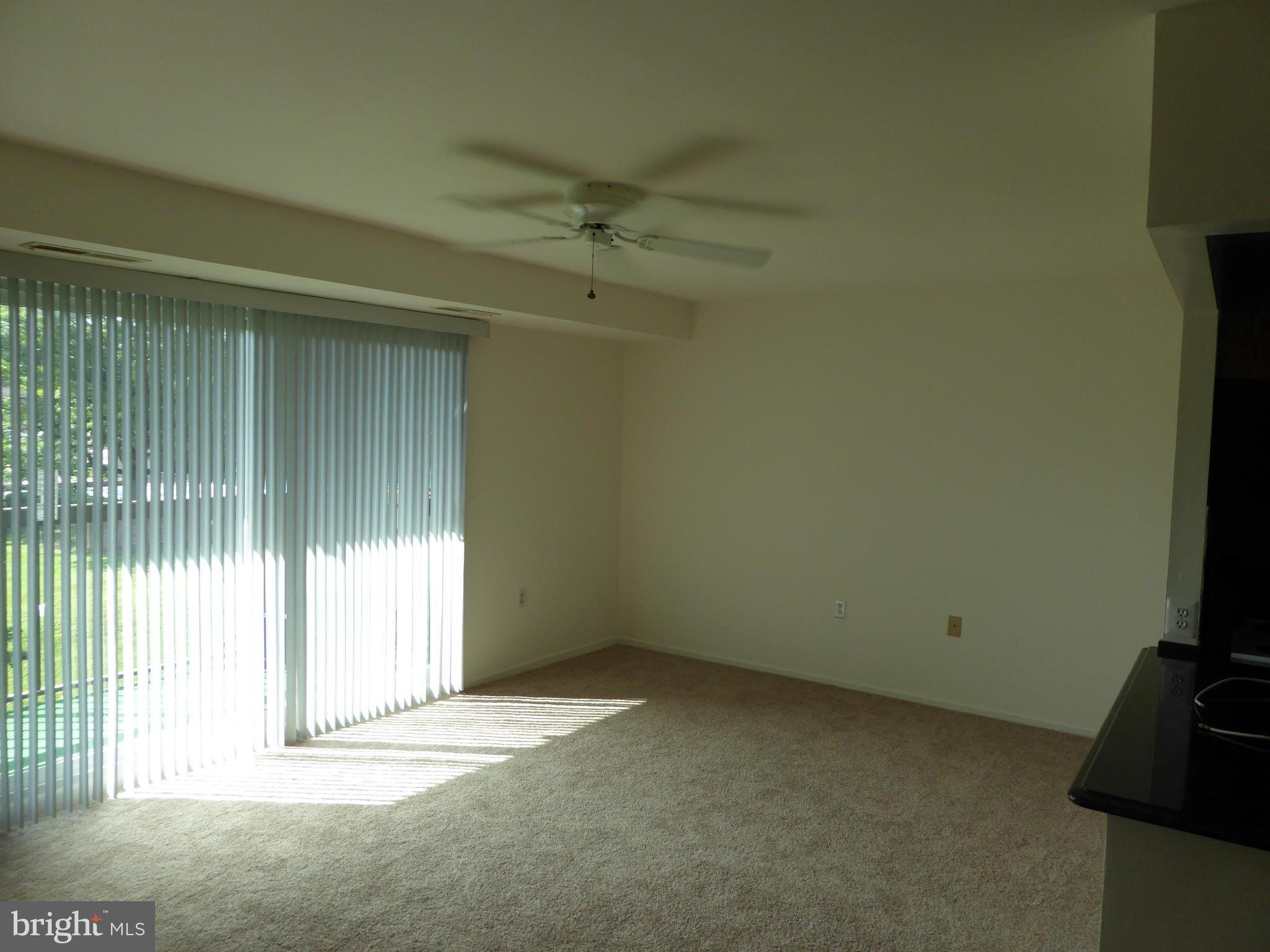 10024 Stedwick Road, Unit 202 Gaithersburg, MD 20886 - Photo 6 of 21 Living Room looking toward SGD to Balcony