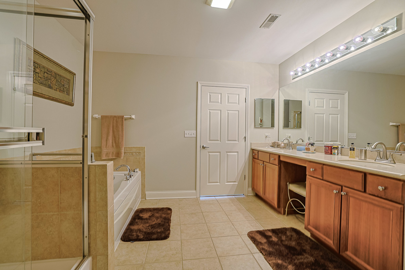 2700 Summit Drive, Unit 401 Glenview, IL 60025 - Photo 23 of 31 a spacious bathroom with a double vanity sink a mirror and shower