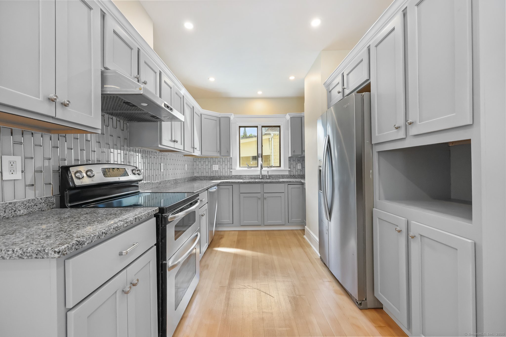 366 Suburban Avenue Fairfield, CT 06825 - Photo 11 of 34 a kitchen with granite countertop a sink a counter top space stainless steel appliances and cabinets