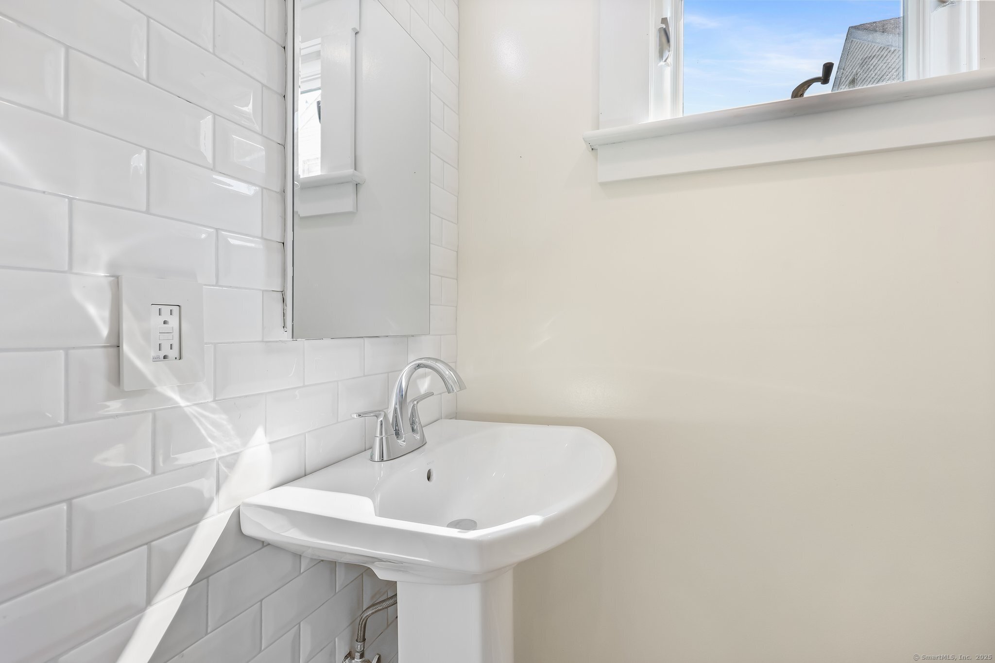 366 Suburban Avenue Fairfield, CT 06825 - Photo 14 of 34 a bathroom with a sink and a mirror