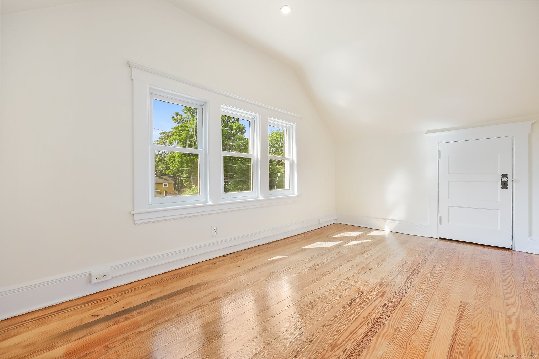 366 Suburban Avenue Fairfield, CT 06825 - Photo 15 of 34 an empty room with wooden floor and windows