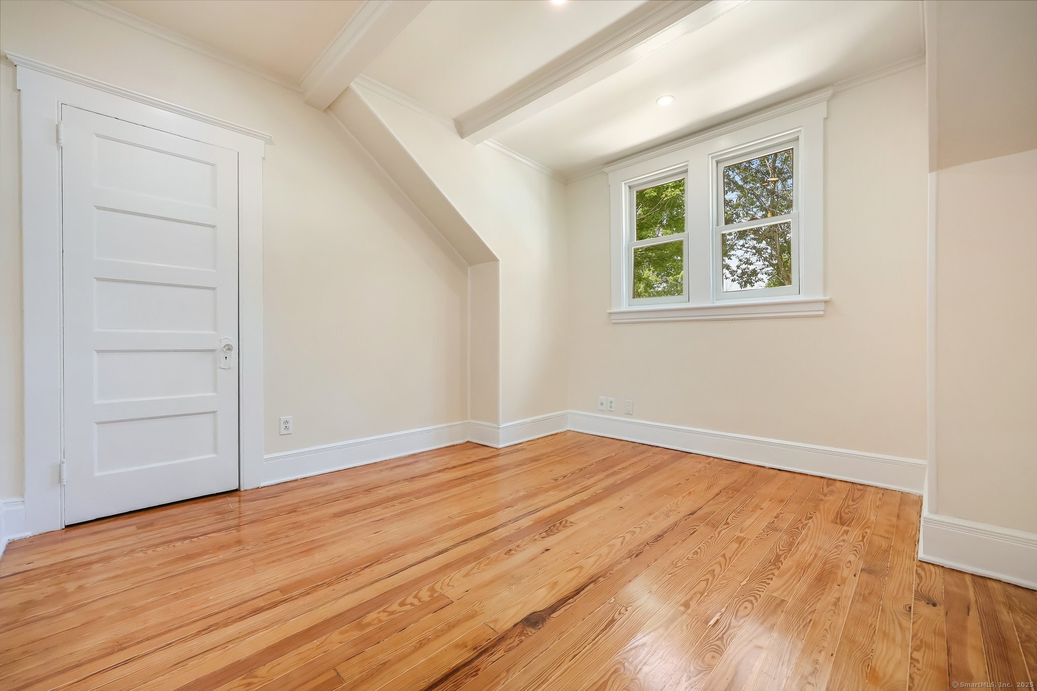 366 Suburban Avenue Fairfield, CT 06825 - Photo 17 of 34 an empty room with wooden floor and window