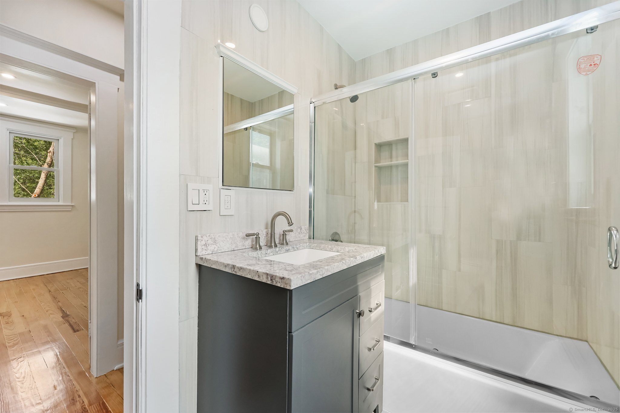 366 Suburban Avenue Fairfield, CT 06825 - Photo 19 of 34 a bathroom with a sink a mirror and a shower