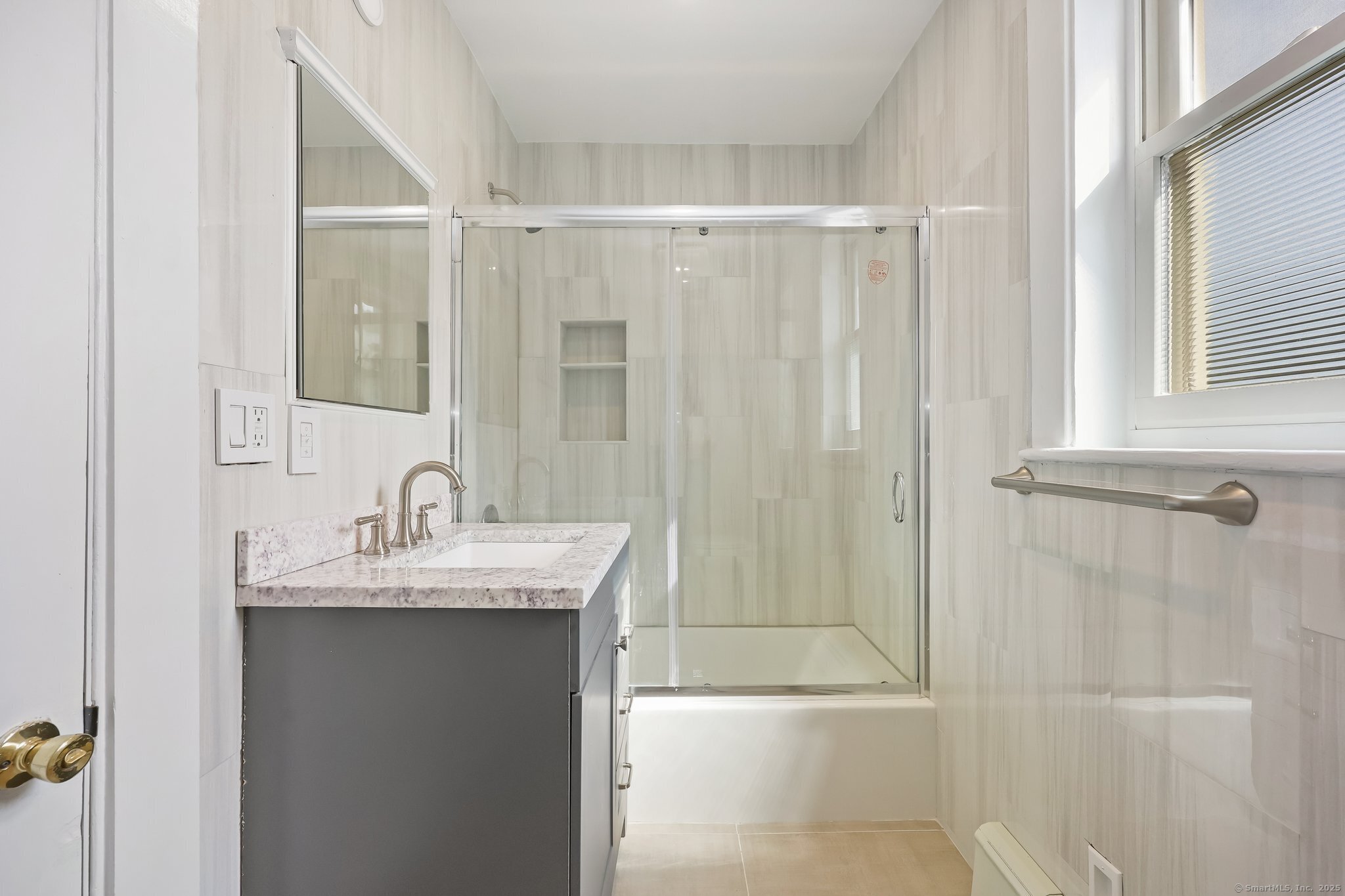 366 Suburban Avenue Fairfield, CT 06825 - Photo 20 of 34 a bathroom with a granite countertop sink a mirror a vanity and shower