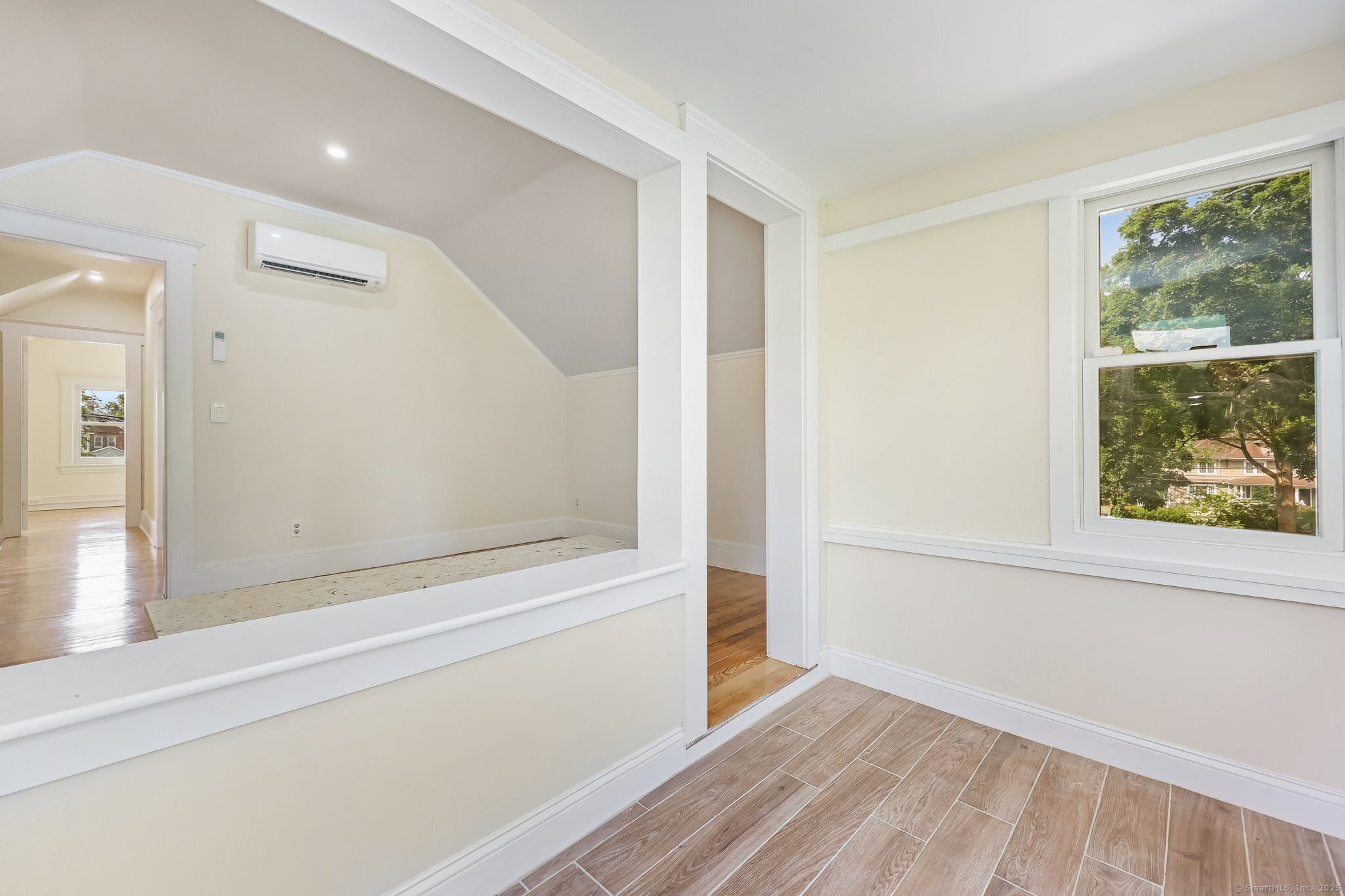366 Suburban Avenue Fairfield, CT 06825 - Photo 25 of 34 an empty room with wooden floor and windows