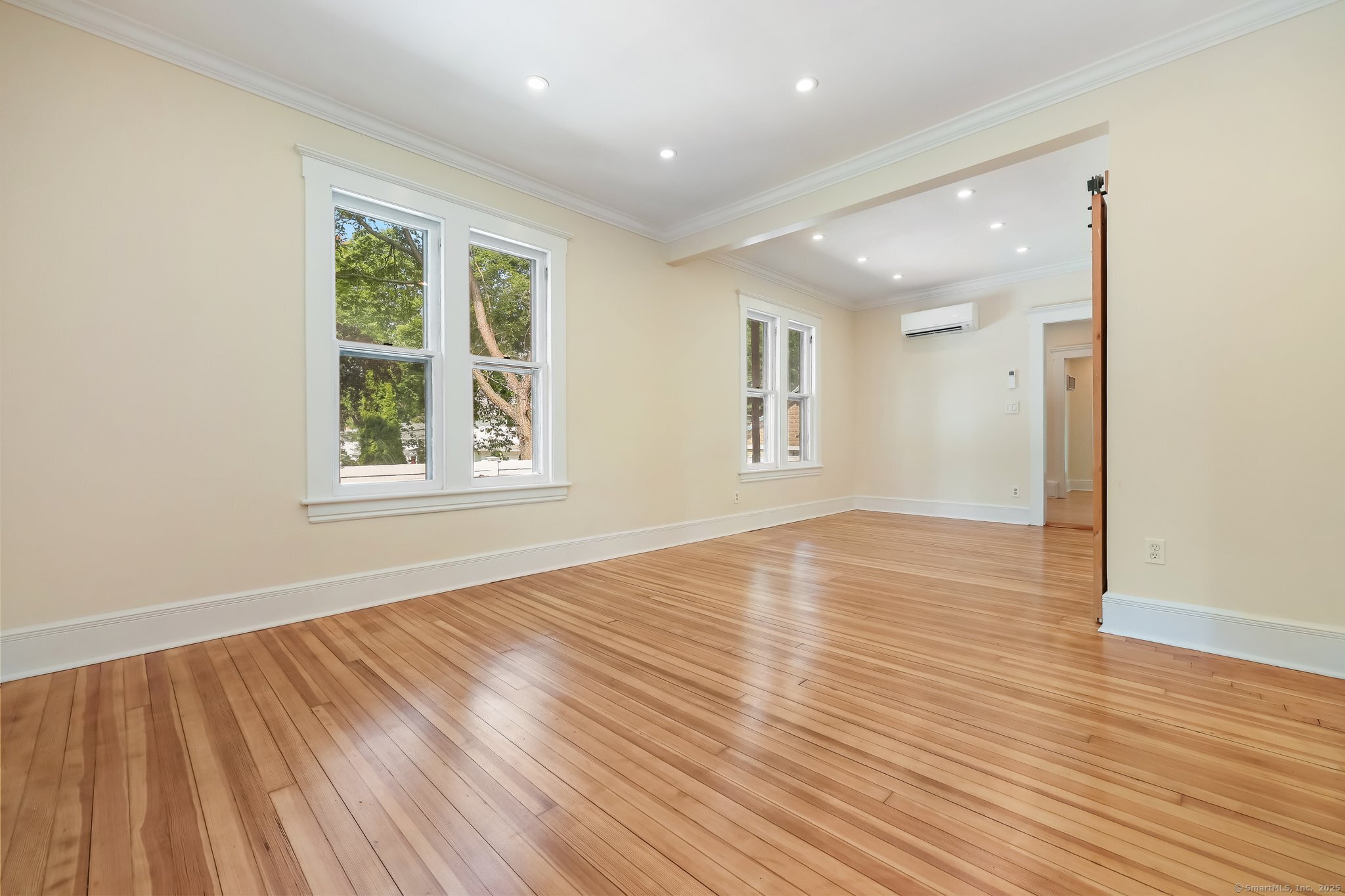 366 Suburban Avenue Fairfield, CT 06825 - Photo 6 of 34 an empty room with wooden floor and windows