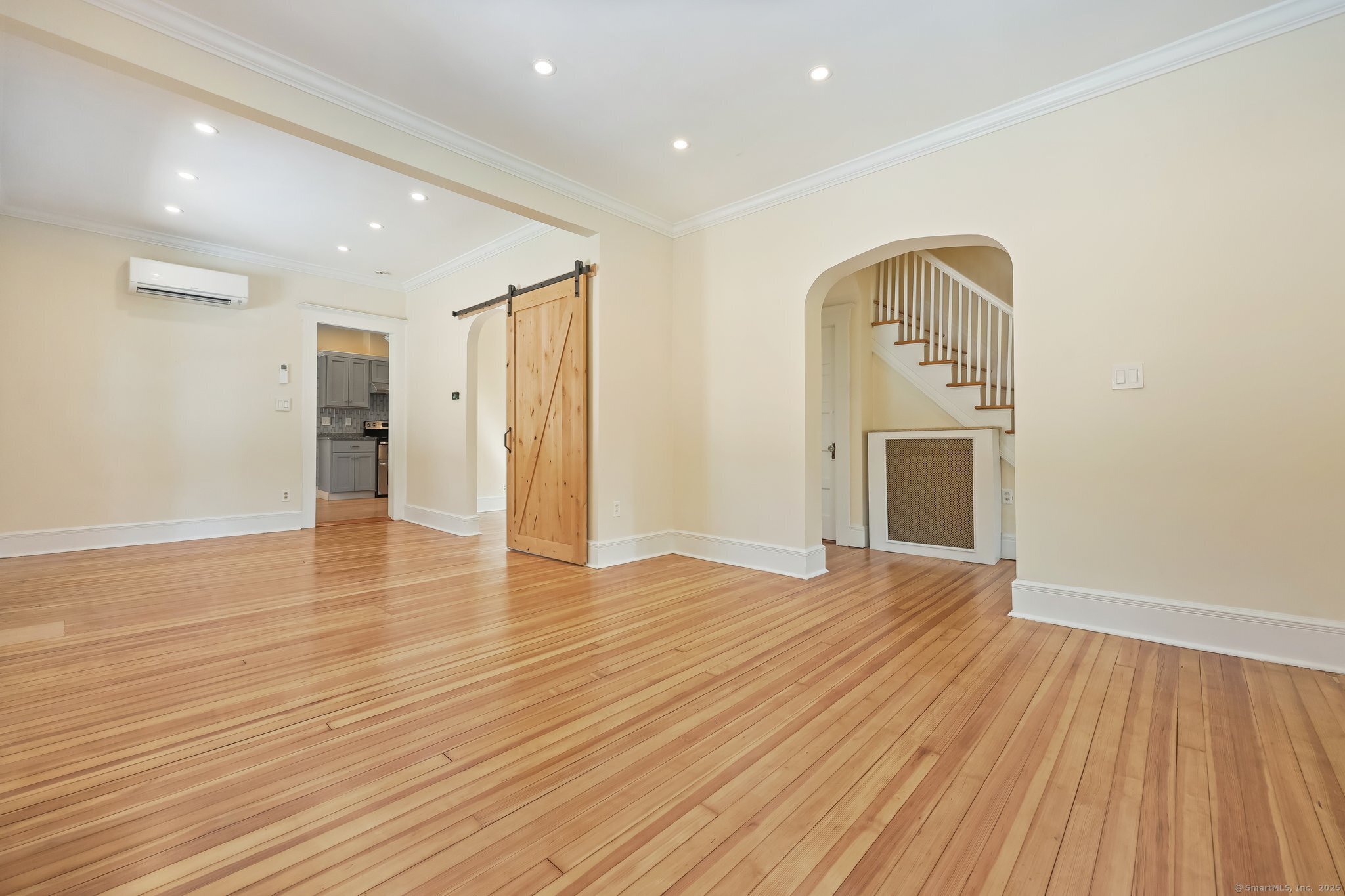 366 Suburban Avenue Fairfield, CT 06825 - Photo 7 of 34 a view of empty room with wooden floor and fireplace