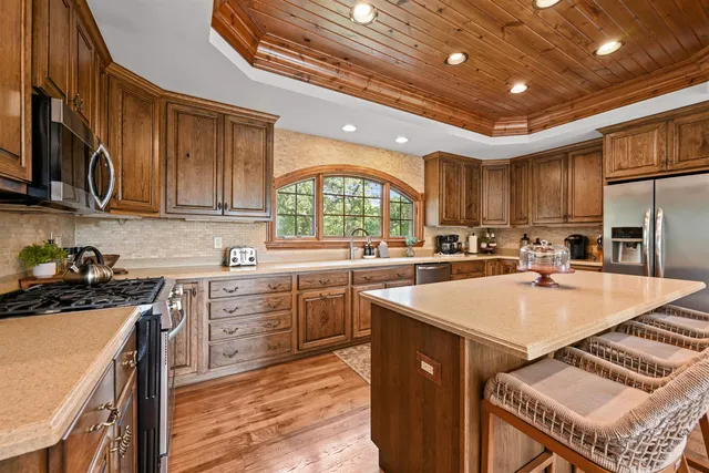 a kitchen with sink a stove and chairs
