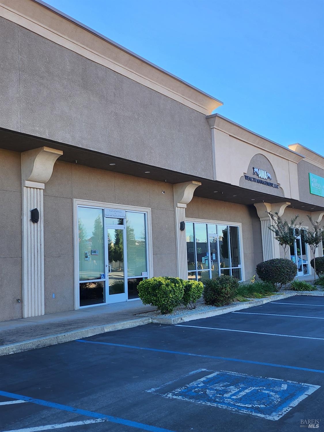 2650 Larkspur Lane, Unit F Redding, CA 96002 - Photo 4 of 5 a front view of a house with a yard and garage