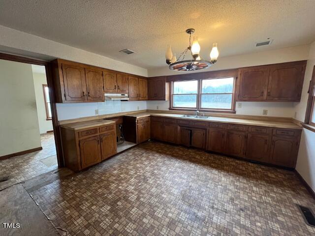 7736 Bill Love Road Willow Spring, NC 27592 - Photo 8 of 16 a kitchen with wooden cabinets and sink