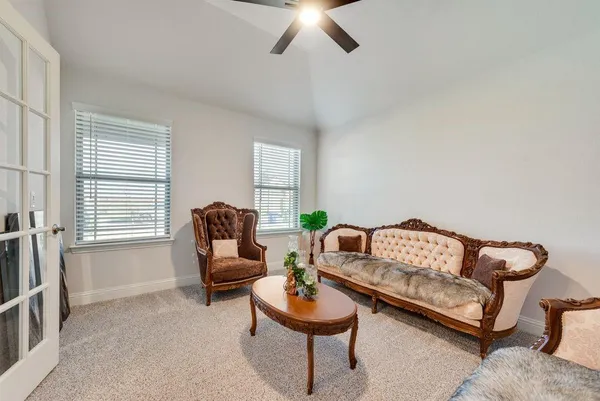 a living room with furniture and a large window