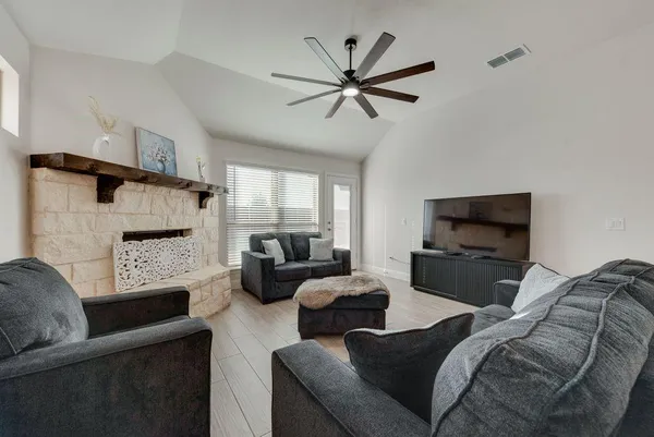 a living room with furniture and a flat screen tv