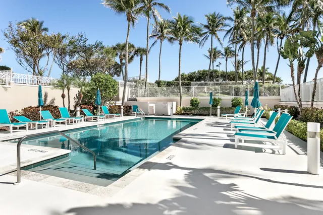 a kitchen with a table chairs and a floor to ceiling window
