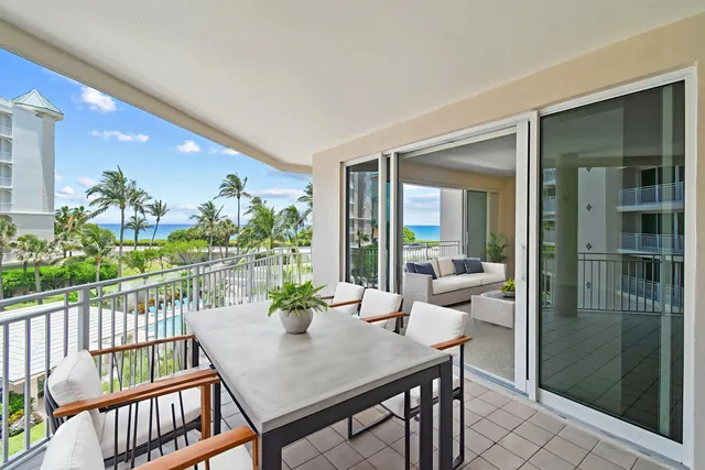 a dining room with furniture and garden view