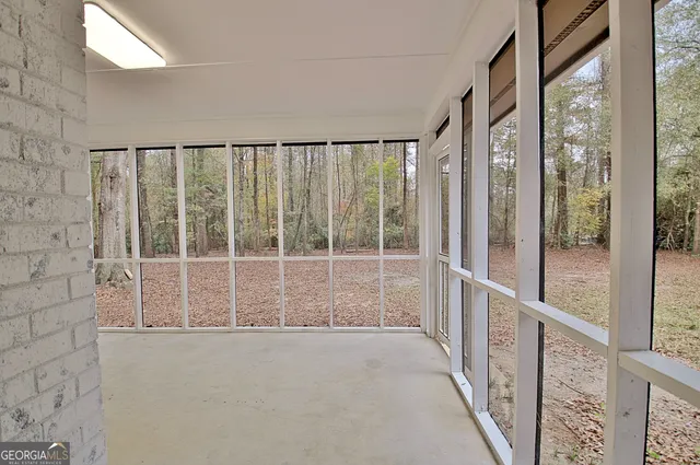 a view of staircase with railing and white walls