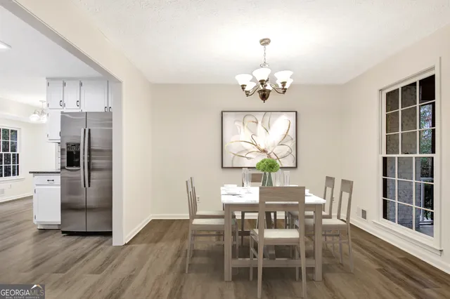 a view of livingroom with hardwood floor and kitchen view