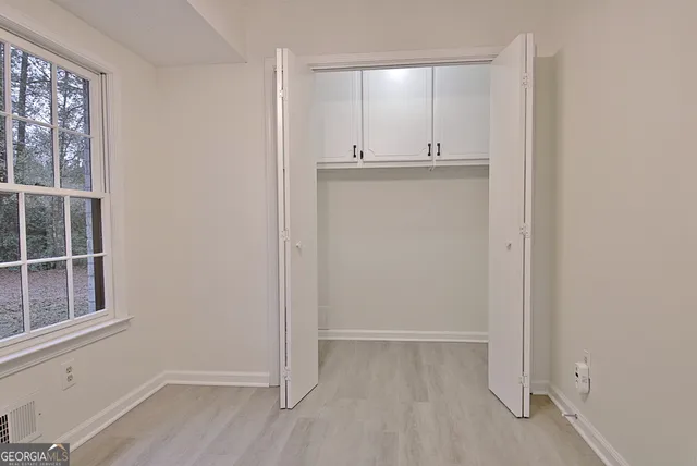 a view of an empty room and wooden floor