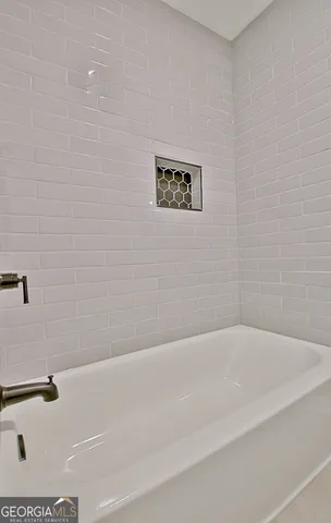 an empty room with a window and ceiling fan