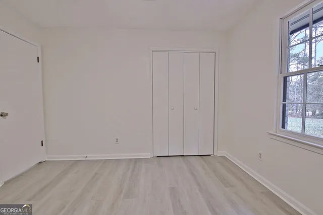 a backyard of a house with large trees