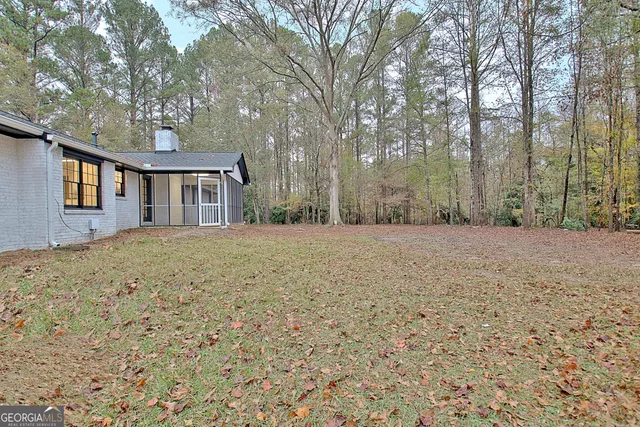 a front view of house with yard and trees