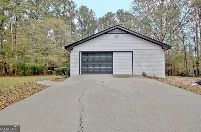 a view of a house with a yard and garage