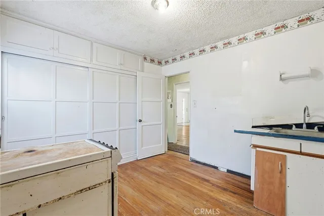 a room with a stove and a refrigerator