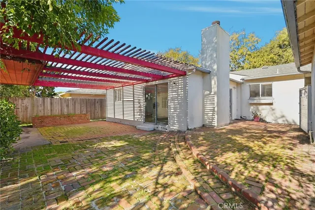 a view of a house with backyard and sitting area