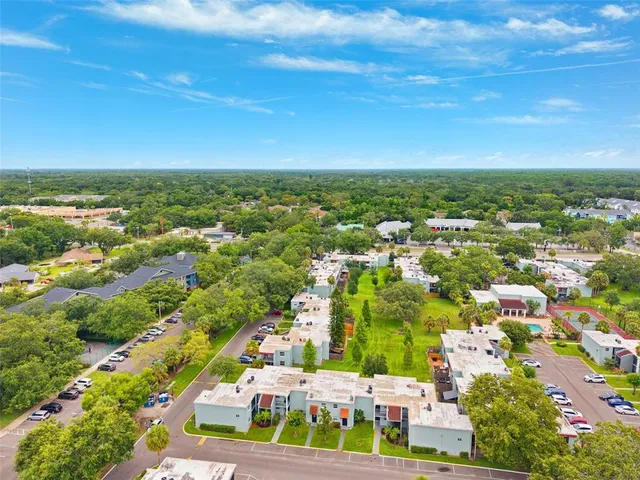 an aerial view of residential houses with outdoor space and street view