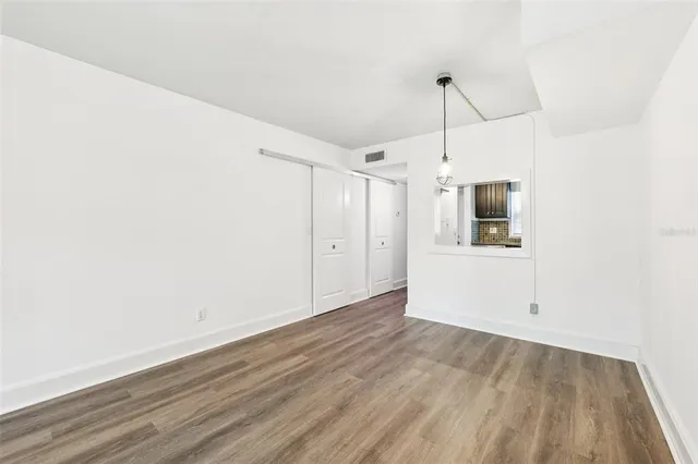 a view of a kitchen with wooden floor