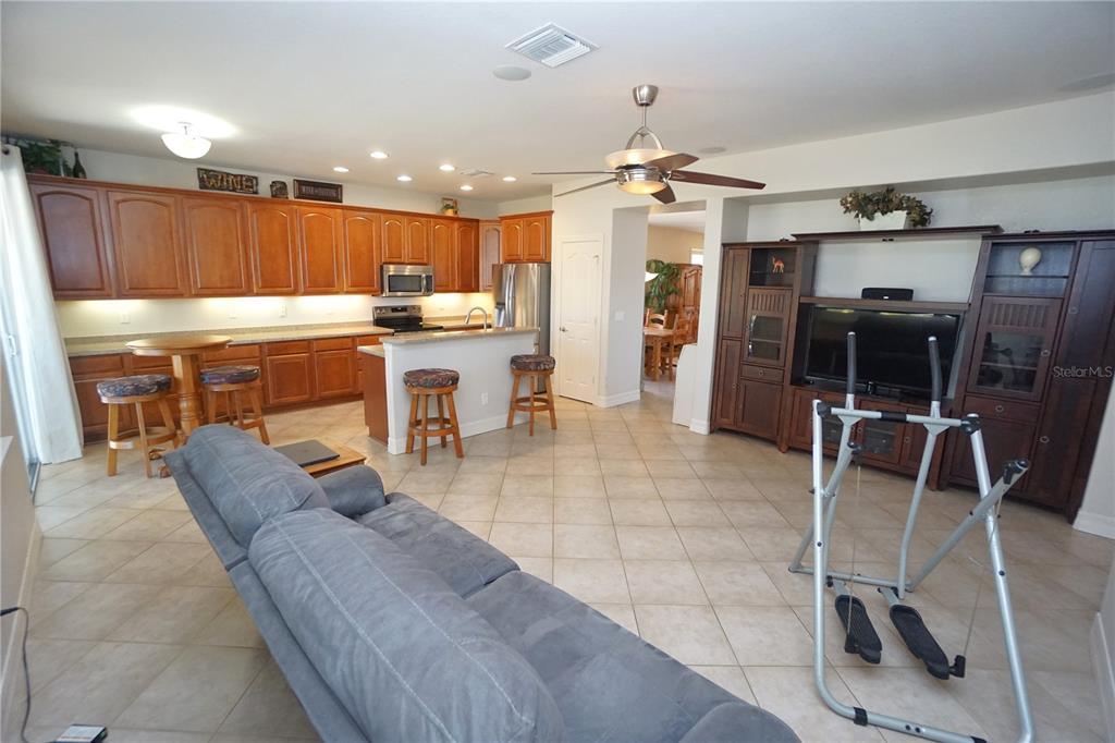 25554 Prada Drive Punta Gorda, FL 33955 - Photo 14 of 56 a living room with stainless steel appliances furniture a rug and kitchen view