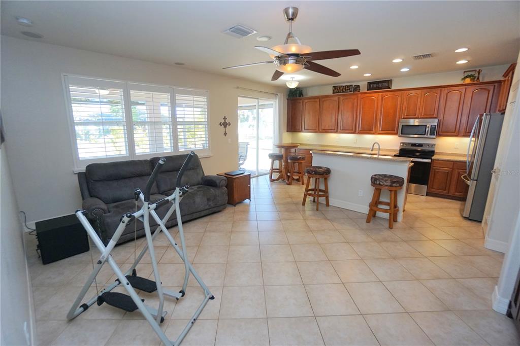 25554 Prada Drive Punta Gorda, FL 33955 - Photo 15 of 56 a room with a table chairs and a view of kitchen