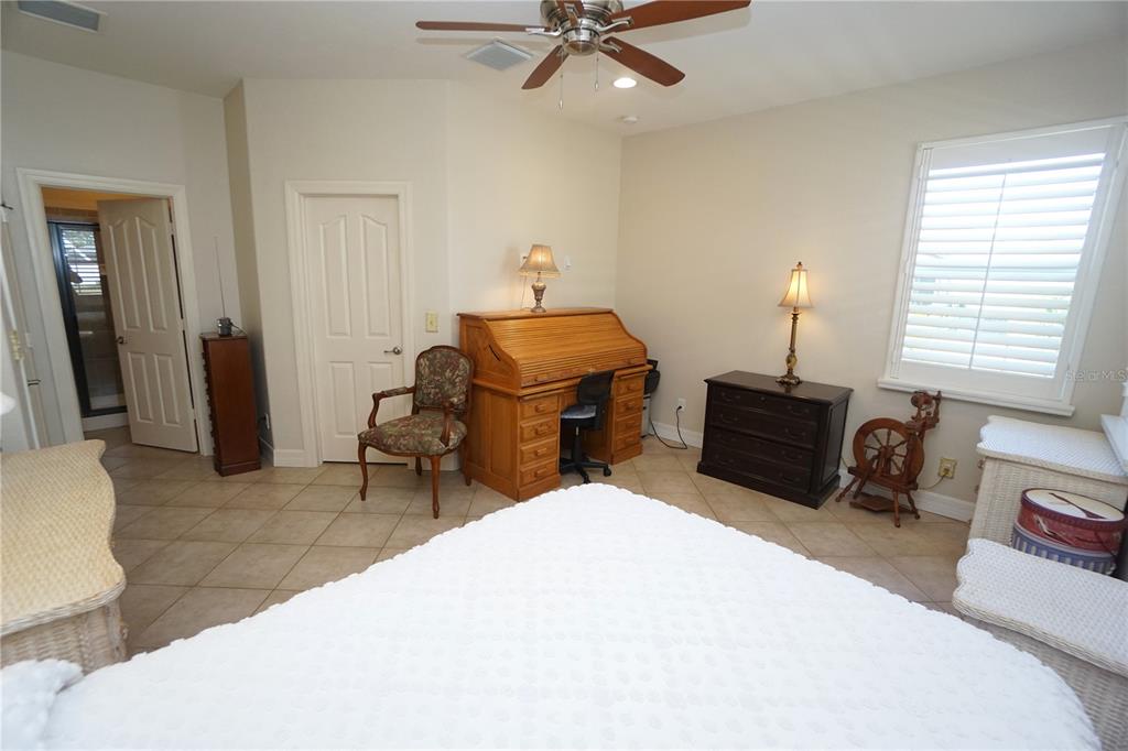 25554 Prada Drive Punta Gorda, FL 33955 - Photo 17 of 56 a bed room with a bed and a chair