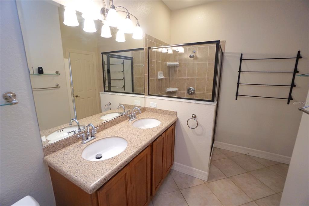 25554 Prada Drive Punta Gorda, FL 33955 - Photo 19 of 56 a bathroom with a sink a mirror a vanity and a shower