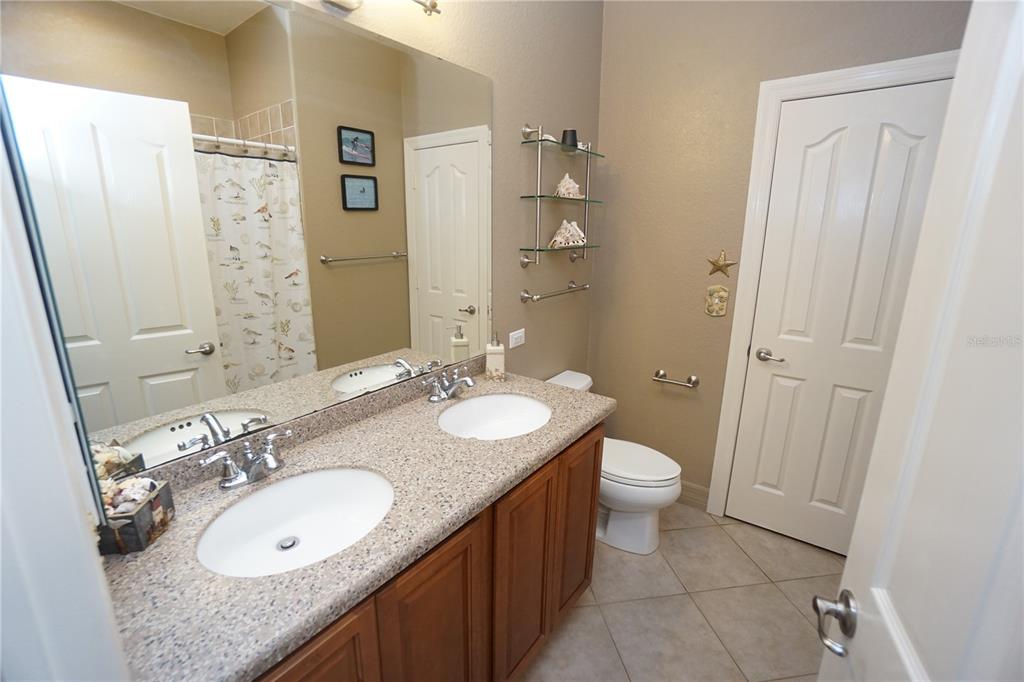 25554 Prada Drive Punta Gorda, FL 33955 - Photo 22 of 56 a bathroom with a granite countertop double vanity sink and a mirror