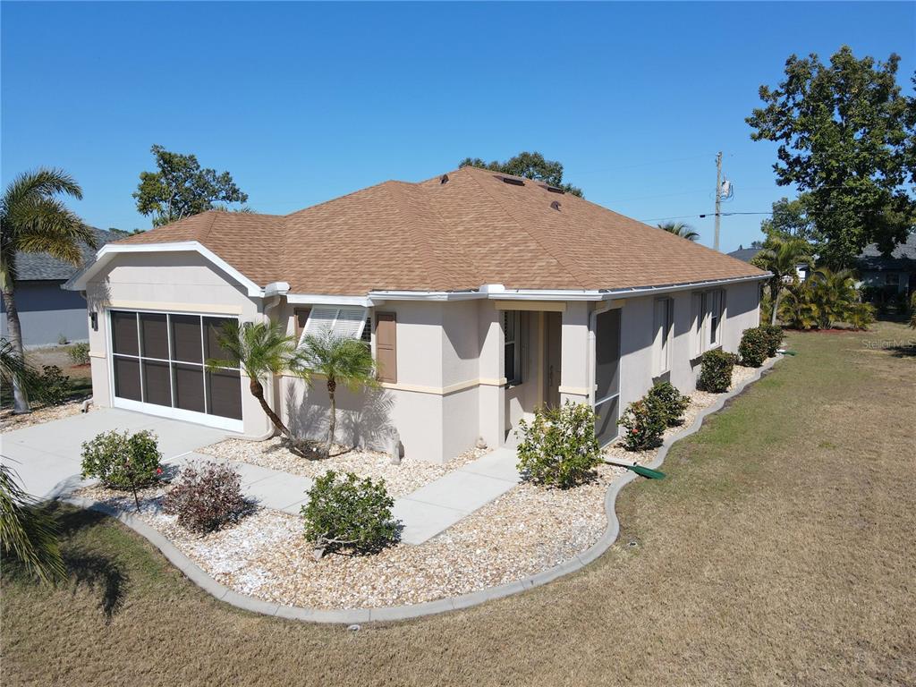 25554 Prada Drive Punta Gorda, FL 33955 - Photo 3 of 56 a front view of a house with garden