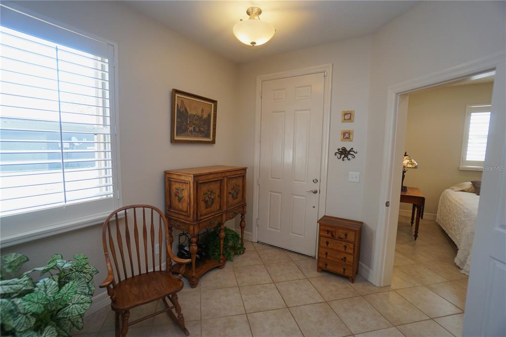 25554 Prada Drive Punta Gorda, FL 33955 - Photo 6 of 56 a spacious bedroom with a bed and a chandelier