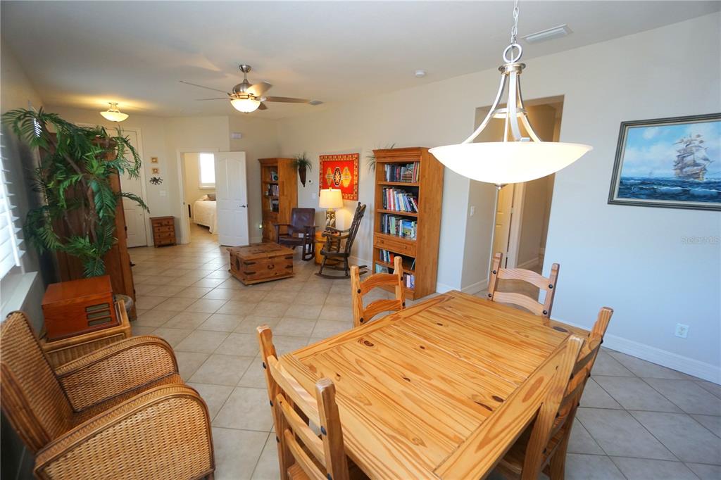 25554 Prada Drive Punta Gorda, FL 33955 - Photo 9 of 56 a dining room with furniture and a chandelier